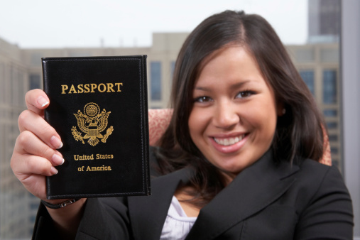 Young professional holds up her passport