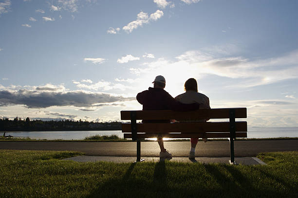 istock Lone Couple On Park Bench At Beach Sunset 172261724