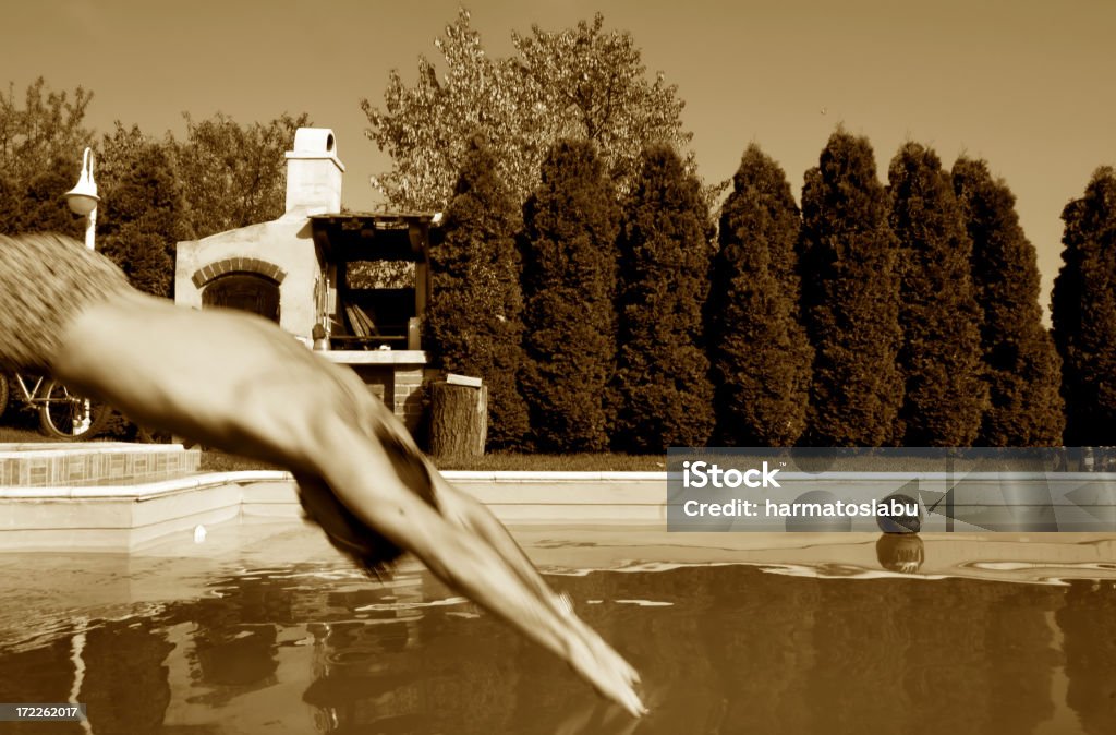 Jump A young man is jumping into the swimming pool. Males Stock Photo