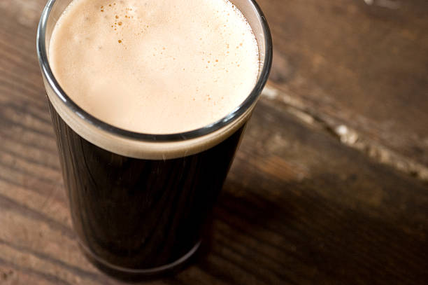 St. Patrick's day stout pint on a wooden surface stock photo