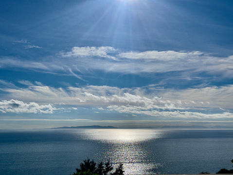 Beauty in Nature with sun beam over Ocean and Tree