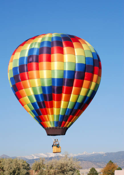 istock Rainbow Checkered Hot Air Balloon Rising Over the Mountains 2 172262782