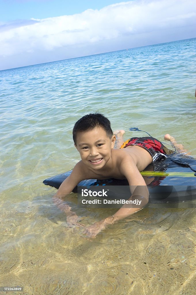 Water Fun Kid playing in the ocean. 6-7 Years Stock Photo