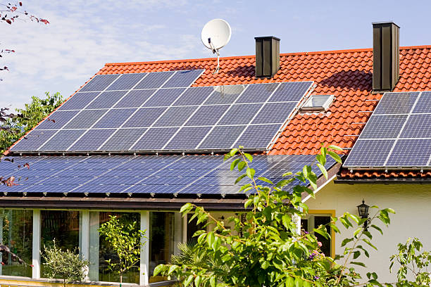 istock Solar panels on a house rooftop 172263059