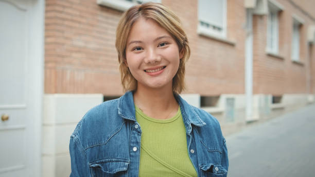 istock Girl dressed in denim jacket looking at the camera with smile 1722633286