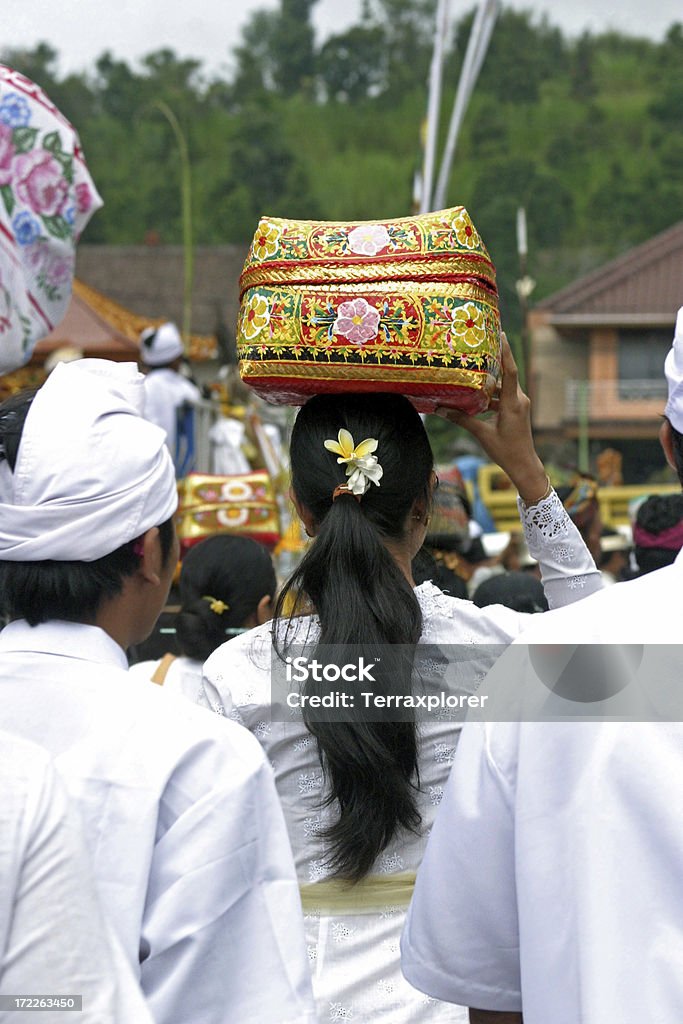 Balinese Woman Carrying Offerings On Her Head "Woman carrying offering after it was blessed at Hindu temple ceremony in Bedugul, Bali, Indonesia." 20-29 Years Stock Photo