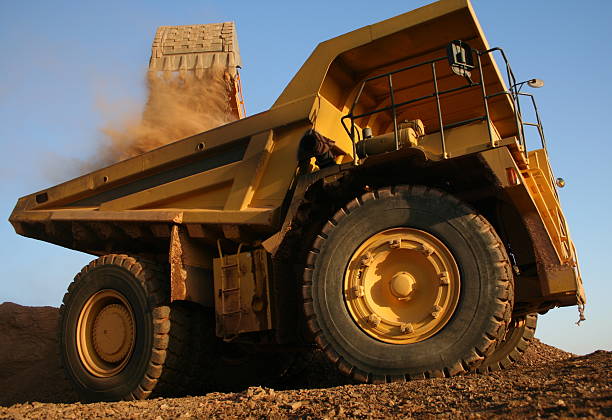 SUPER TRUCKS Big Big mining machines in action. construction truck bulldozer wheel stock pictures, royalty-free photos & images