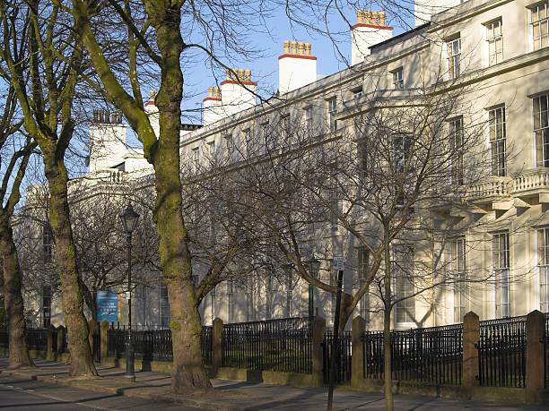 istock Georgian three storey terraced houses on a tree lined road 172263890