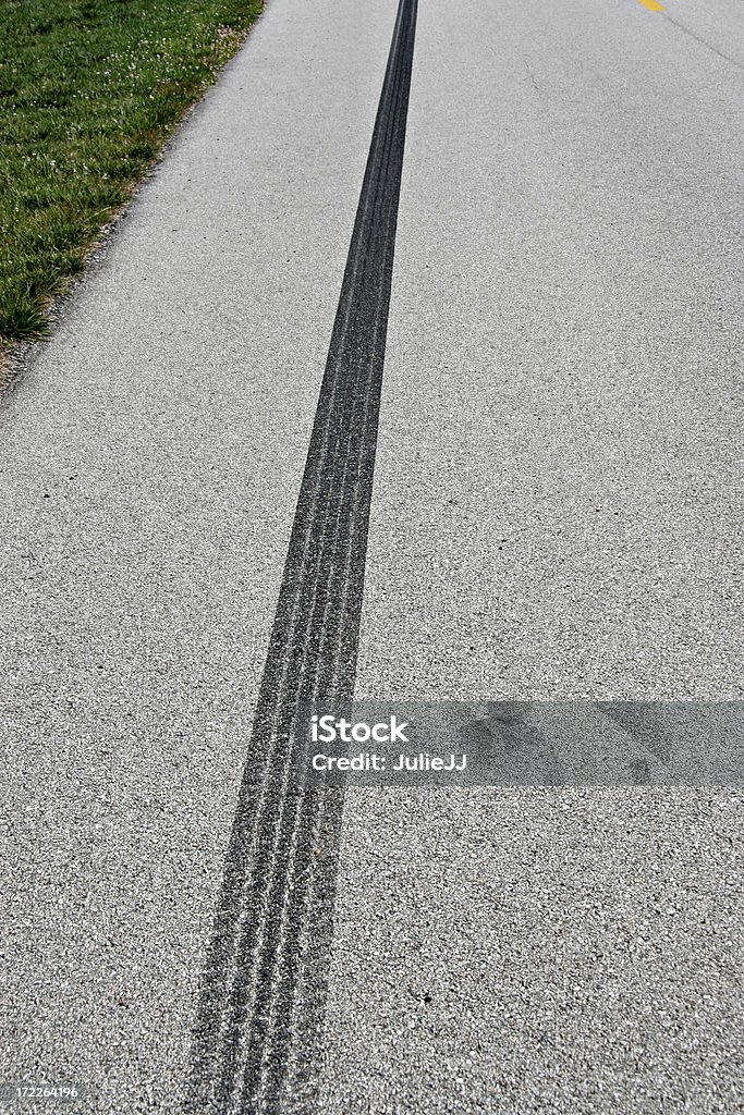 Acceleration mark An accelerating vehicle left a little rubber on the asphalt. Asphalt Stock Photo