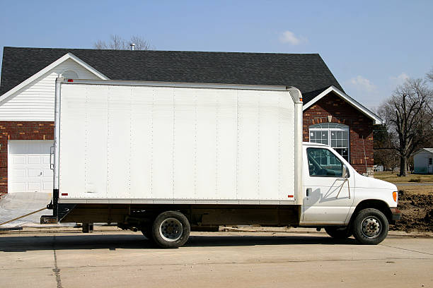 Large plain white removal van parked outside of a house  Van parked in front of a new home moving van stock pictures, royalty-free photos & images