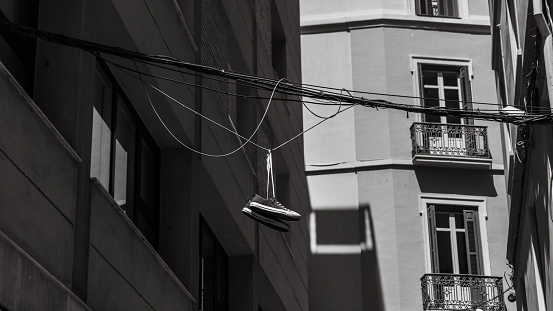 Sneakers hanging from a wire in the street