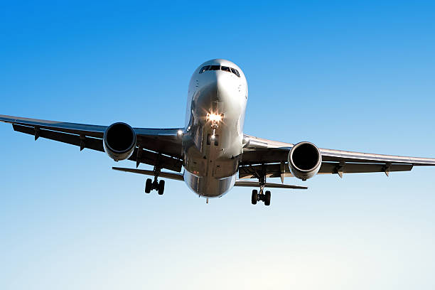 istock jet airplane landing in clear blue sky 172264684