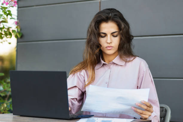 istock Successful busy business woman work looking documents thinking over financial data report or sales chart in city cafe 1722649336