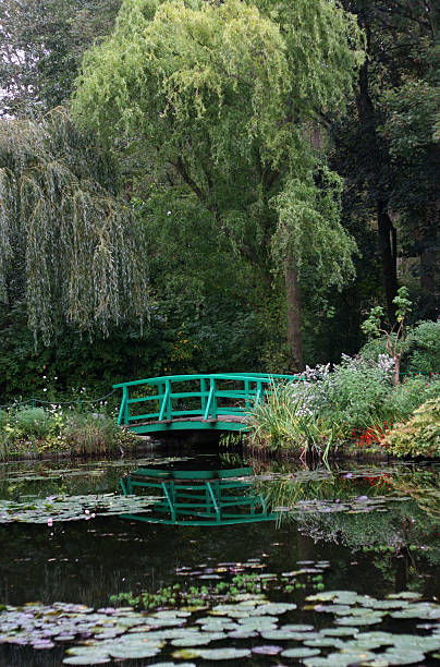 Monet's Lily Pond Bridge "Monet's lily pond bridge in the garden outside his house in Giverny, France." giverny stock pictures, royalty-free photos & images