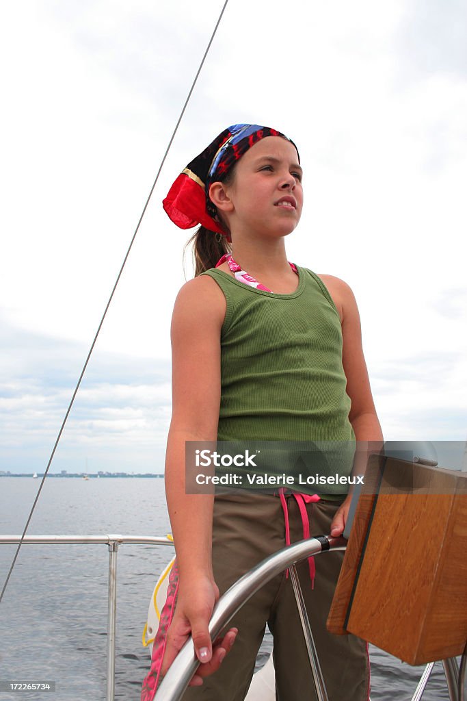 Girl on the boat Girl with Ship Wheel on the boat. Child Stock Photo