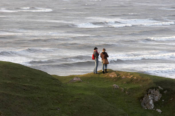 Two young ladies on a remote cliff top on the Gower Peninsula in Wales