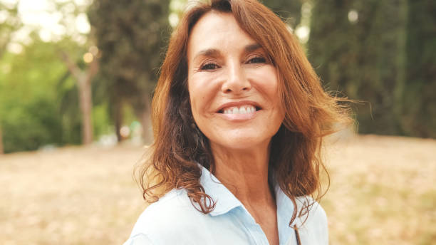 istock Close-up of beautiful elderly woman smiling while looking at the camera 1722659068