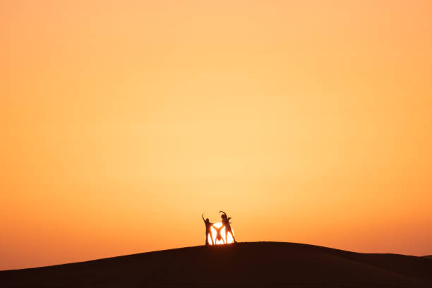 istock Friends walks across sand dunes, at sunrise 1722663753