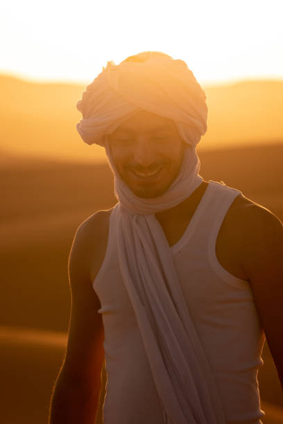 istock Young man walks across sand dune at sunrise 1722664887