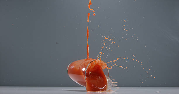 istock Glass of Tomatoe's Juice falling 1722664924