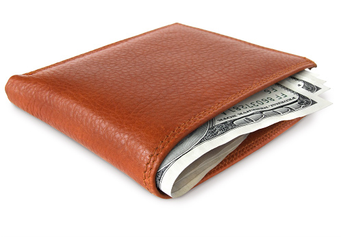 Brown leather wallet full of money.