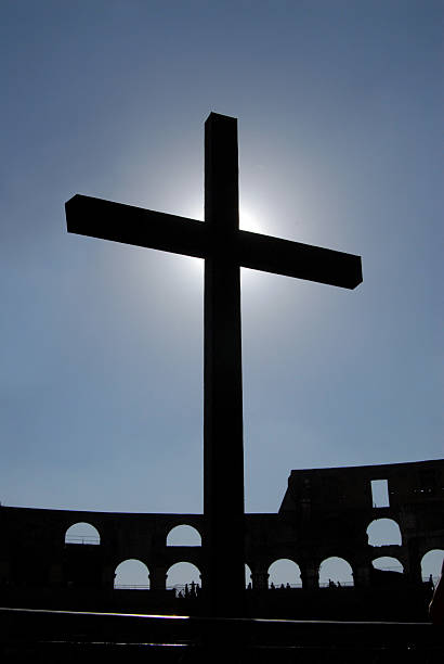 Silhouette of a cross stock photo