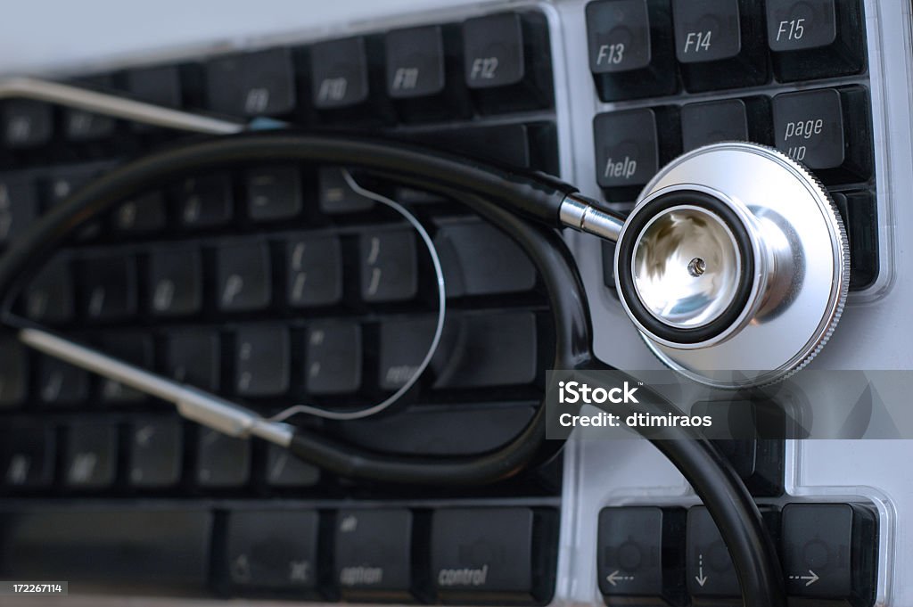 Stethoscope on keyboard Close up of stethoscope on keyboard. Symbolic of technology and medicine. Above Stock Photo