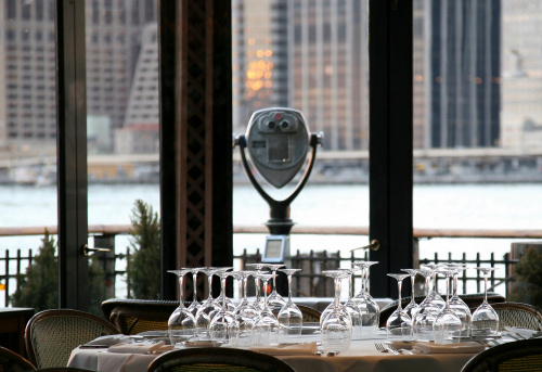 Wineglasss and place settings on dining table in restaurant, New York City, New York, USA.