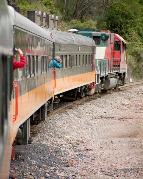 Copper Canyon (Barranca del Cobre) of Mexico: Passengers on the train up the canyon lean out from between cars to take pictures of the colorful canyon.More Copper Canyon photos in the lightbox at http://www.istockphoto.com/my_lightbox_contents.phplightboxID=1583684