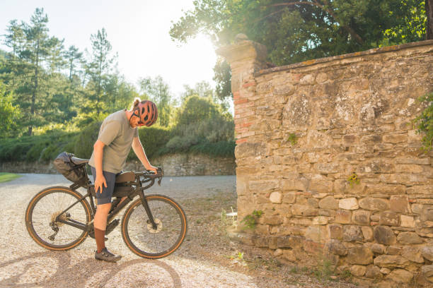 istock Road cyclist takes a break on country road 1722681263