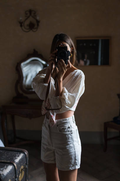 She takes photos of her outfit, while relaxing at home
