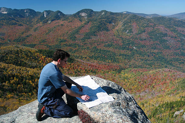 istock Man Hiker Looking at Map on Mountain Summit in Autumn 172268265