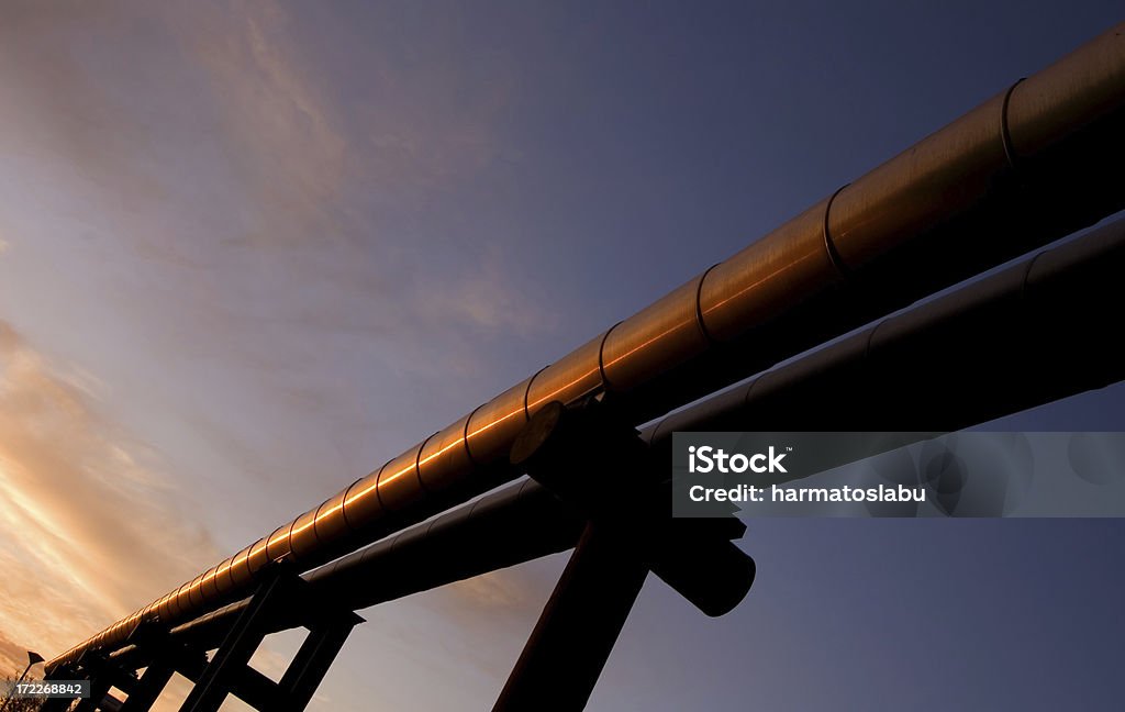 Above the ground Huge pipelines in the lights of sunrise. Pipeline Stock Photo