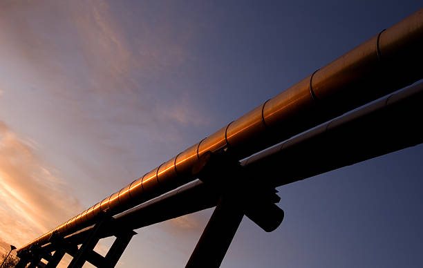 Above the ground Huge pipelines in the lights of sunrise. pipeline stock pictures, royalty-free photos & images