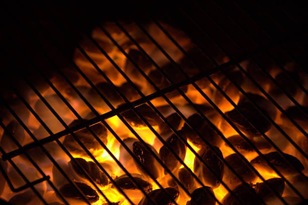 Charcoal on fire in a BBQ grill. stock photo