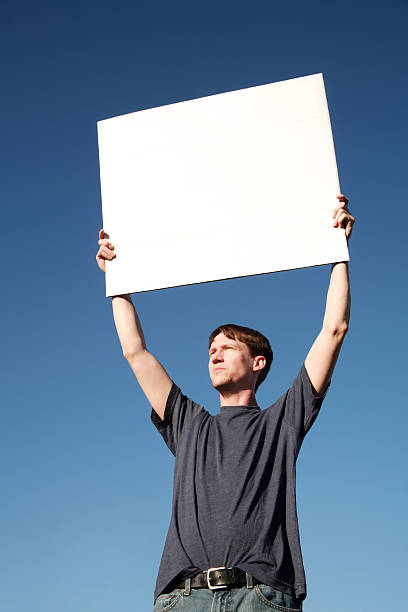 Man Holding Blank Sign Over Head stock photo