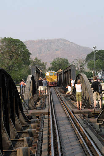 River Kwai bridge, Thailand. Poeple looking at the train coming.