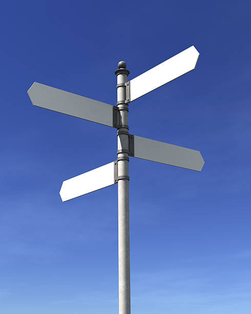 A pole with 4 blank street signs pointing at 4 directions Blank signpost with four arrows over blue sky - just add your text. crossroads sign stock pictures, royalty-free photos & images