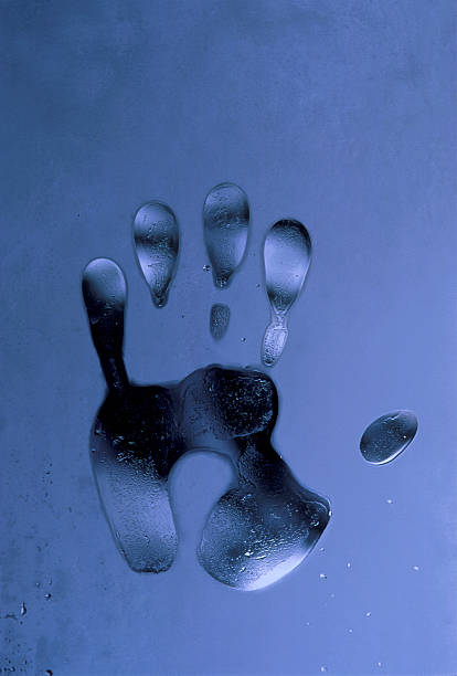 Hand print on frosty window stock photo