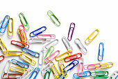 Various colored paperclips on white background