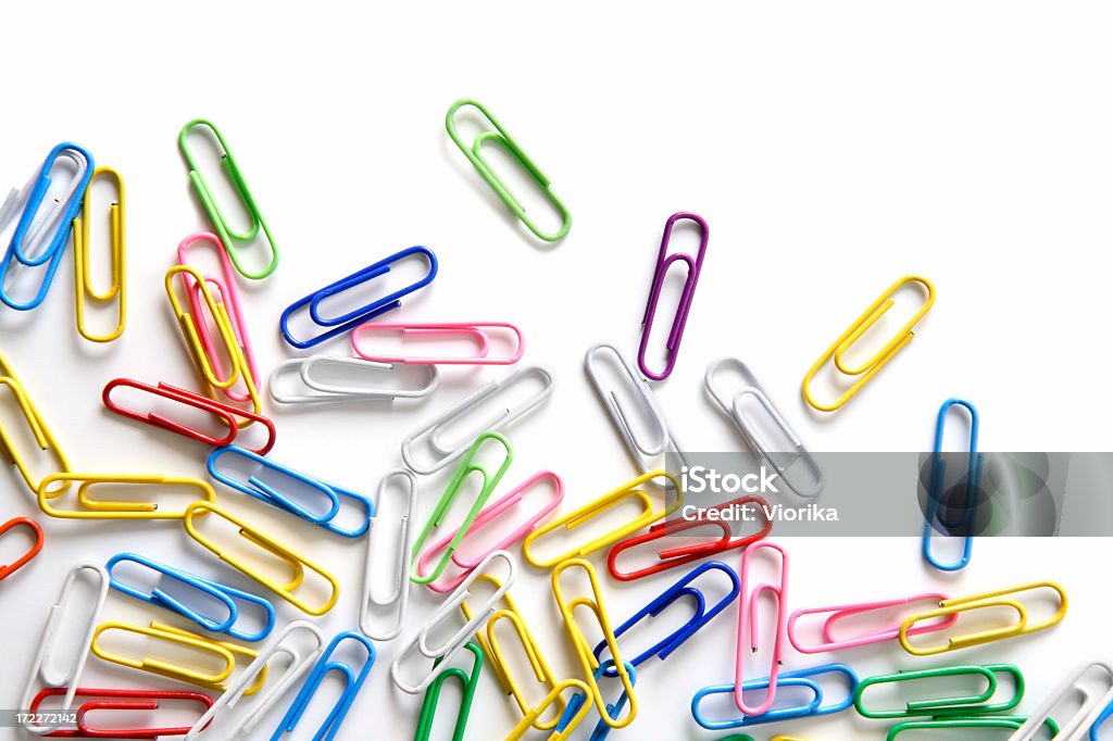 Various colored paperclips on white background Close-up of multi-colored paper clips on a white background. Paper Clip Stock Photo