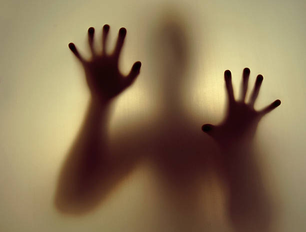 istock Silhouette of Figures Pressing Hands to a Window 172272272