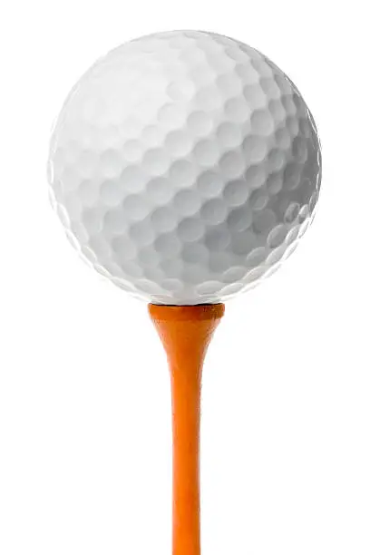 "White golf ball stands on tall, wooden orange tee. Isolated on white."