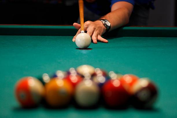 Playing pool Young man playing pool pool break stock pictures, royalty-free photos & images