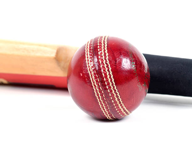 istock Red leather cricket ball with red and tan stripes 172273055