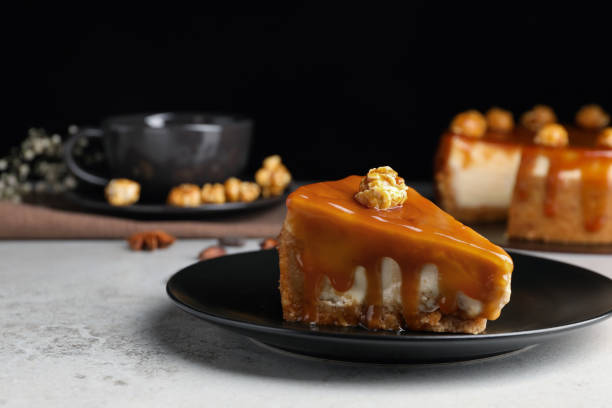 istock Piece of delicious cake with caramel and popcorn on light grey table, space for text 1722739310
