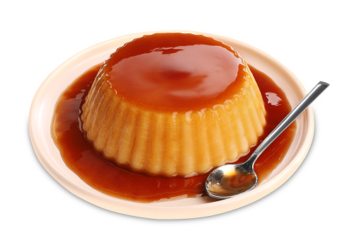 Delicious pudding with caramel isolated on white