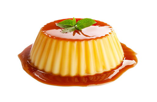 Delicious pudding with caramel and mint isolated on white