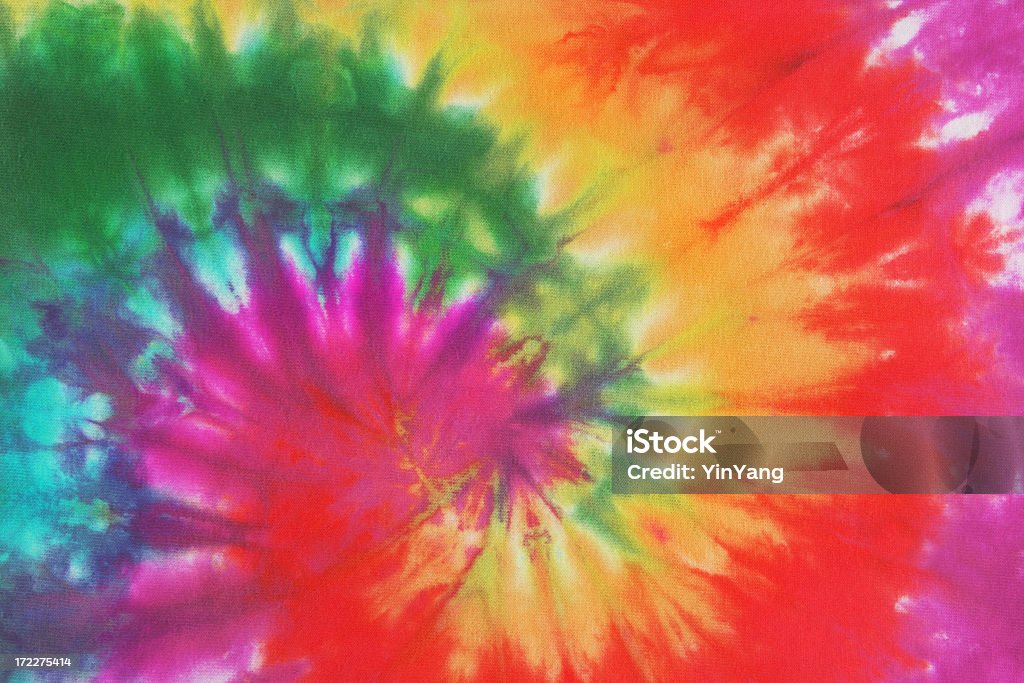 Psychedelic Tie Dye, a 1960s Style Symbol of Peace Background Colorful tie dye fabric with spiral circle pattern in rainbow colors. The free-form pattern is associated with 1960s and 1970s fashion style and a symbol of peace and the peace movement of that era. The multi-colored array of vibrant color was the essence of cool, groovy, psychedelic trends. Psychedelic Stock Photo