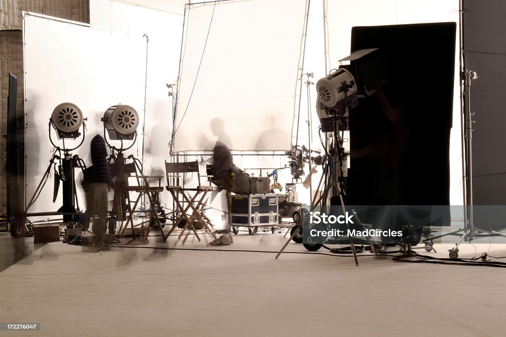 television production with long exposure. Television production taken with a long exposure in a white site surrounding area. Camera equipment and lights surround the studio.Also in this series: Movie Stock Photo